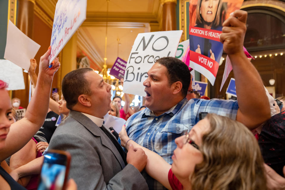 The Rev. Michael Shover of Christ the Redeemer Church in Pella, left, argues with Ryan Maher, of Des Moines as anti-abortion and abortion rights protesters clash in the Iowa Capitol rotunda on July 11, 2023. (Zach Boyden-Holmes / The Register / USA Today Network)