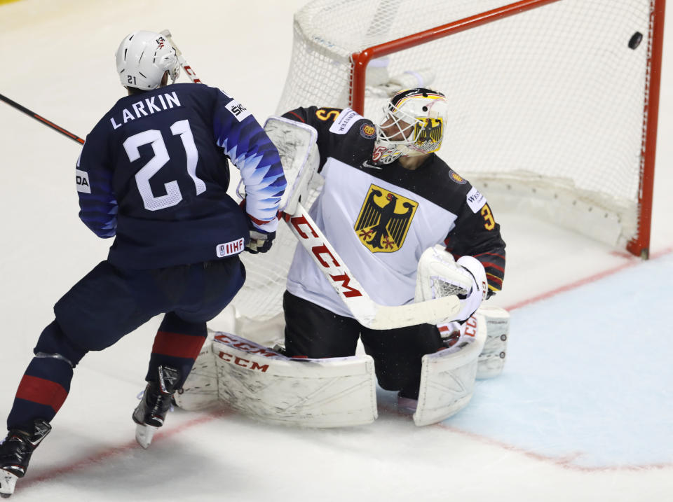 Dylan Larkin of the US, left, scores his sides second goal past Germany's goaltender Matthias Niederberger, right, during the Ice Hockey World Championships group A match between Germany and the United States at the Steel Arena in Kosice, Slovakia, Sunday, May 19, 2019. (AP Photo/Petr David Josek)