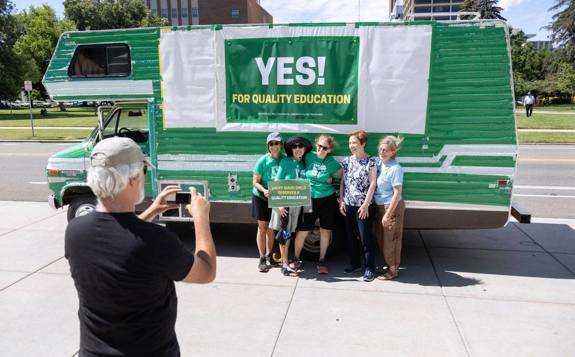 Reclaim Idaho supporters, left to right, Roberta D’Amico, Cay Marquart, Tracy Olson, Karen Lansing and Denise Caruzzi have their photo taken by John Segar in front of the Idaho Capitol on Wednesday.