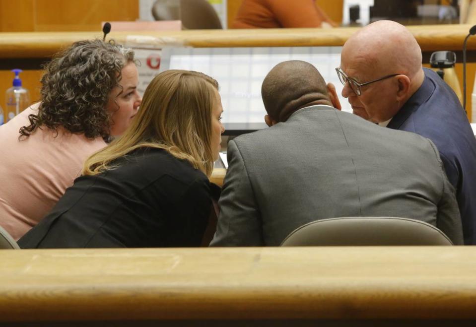 Richland School Board members Kari Williams, Audra Byrd and Semi Bird, from left, talk to their attorney Jerry Moberg before the start of a hearing in Benton County Superior Court.