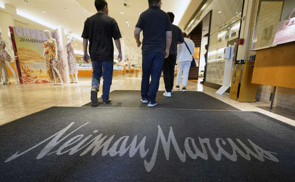 Shoppers walk into the Neiman Marcus retail department store at NorthPark shopping center in Dallas, Thursday, March 30, 2023. Wealthier shoppers are still spending freely even in the face of higher inflation and a volatile economic environment. Luxury retailer Neiman Marcus is doubling down on catering to its high end shoppers. (AP Photo/LM Otero)