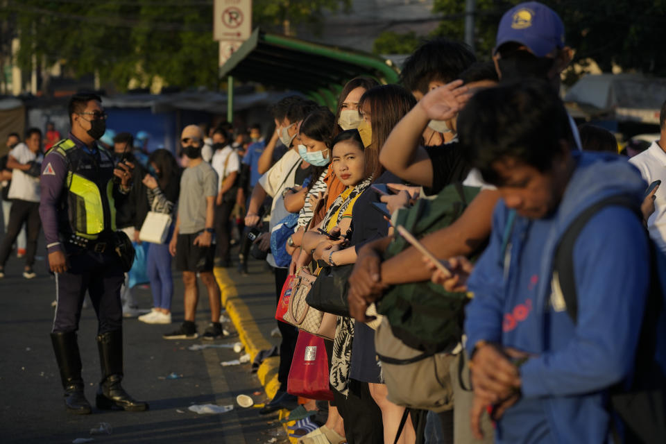 Commuters wait for a ride during a transport strike in Quezon city, Philippines on Monday, March 6, 2023. Philippine transport groups launched a nationwide strike Monday to protest a government program drivers fear would phase out traditional jeepneys, which have become a cultural icon, and other aging public transport vehicles. (AP Photo/Aaron Favila)