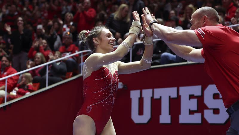 Utah’s Grace McCallum is congratulated by vault coach Jimmy Pratt as No. 4 Utah takes on No. 5 UCLA at the Huntsman Center in Salt Lake City on Friday, Feb. 3, 2023.