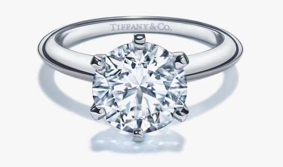 Large diamond, silver-colored engagement ring with Tiffany & Co. printed inside the band.