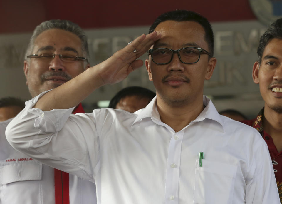 Indonesian Youth and Sports Minister Imam Nahrawi salutes after a press conference in Jakarta, Indonesia, Thursday, Sept. 19, 2019. Nahrawi has stepped down from his position after being named a bribery suspect by the country's anti-graft commission. (AP Photo/Tatan Syuflana)