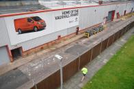 A man runs past the perimeter of Vauxhall's Luton plant in Luton