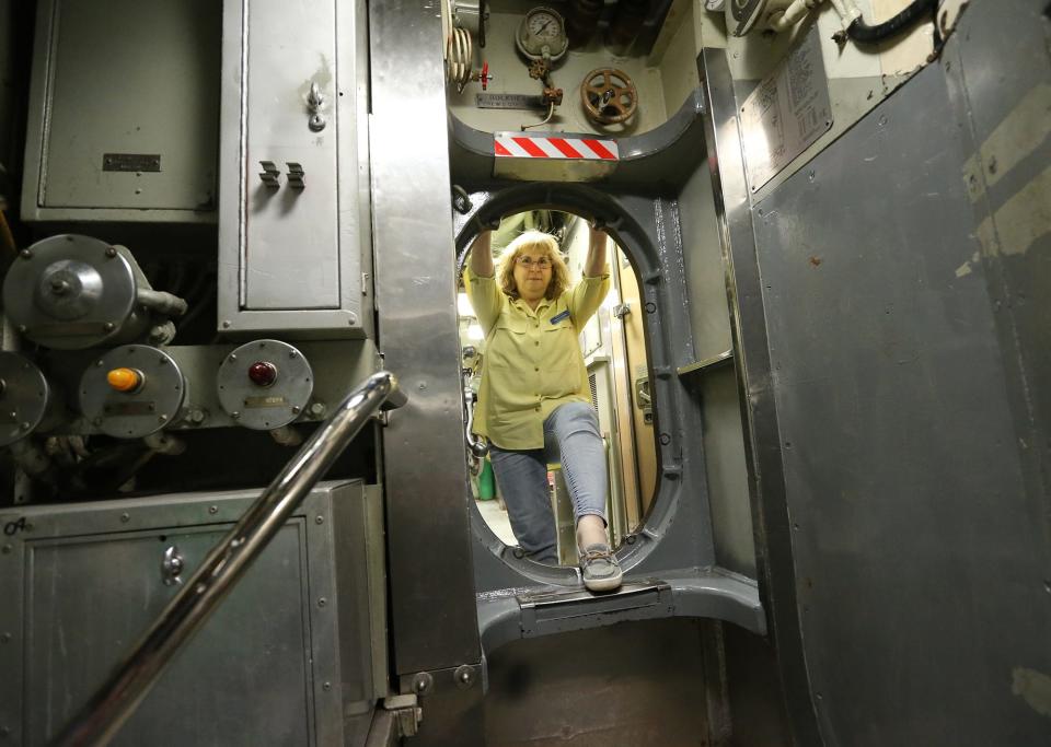 Patricia Violette-Adams, executive director of Albacore Park, moves through the submarine Monday, May 22, 2023.