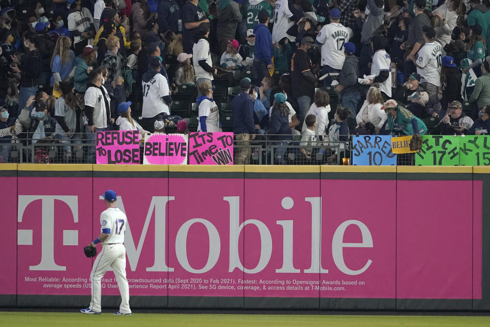 Seattle Mariners right fielder Mitch Haniger (17) watches as fans track a solo home run hit by Los Angeles Angels' Shohei Ohtani during the first inning of a baseball game, Sunday, Oct. 3, 2021, in Seattle. (AP Photo/Ted S. Warren)