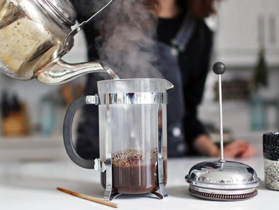 Lauren Singer pours hot water into a french press full of coffee