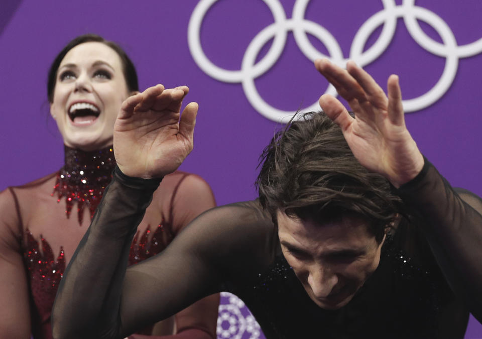 Tessa Virtue and Scott Moir of Canada react to winning the gold medal following their performance in the ice dance, free dance figure skating final in the Gangneung Ice Arena at the 2018 Winter Olympics in Gangneung, South Korea, Tuesday, Feb. 20, 2018. (AP Photo/David J. Phillip)