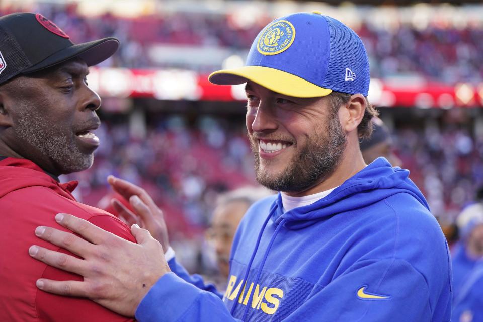 San Francisco 49ers assistant coach Anthony Lynn, left, talks with Los Angeles Rams quarterback Matthew Stafford after the regular season finale in Santa Clara, Calif., Sunday, Jan. 7, 2024.