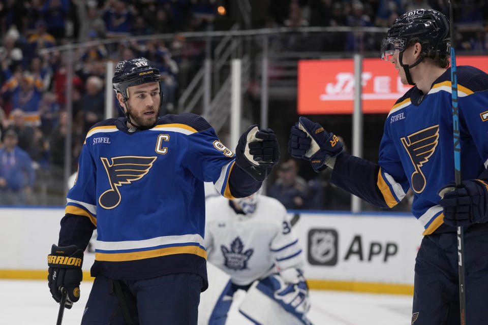 St. Louis Blues' Ryan O'Reilly, left, is congratulated by Niko Mikkola after scoring during the second period of an NHL hockey game against the Toronto Maple Leafs Tuesday, Dec. 27, 2022, in St. Louis. (AP Photo/Jeff Roberson)