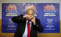 Geoff Stone poses for a picture as he pretends to smoke from a pipe following his audition for "Rob Ford The Musical: The Birth of a Ford Nation" in Toronto, June 16, 2014. Toronto Mayor Rob Ford, who shot to prominence last year after admitting to smoking crack, buying illegal drugs and driving after drinking, insisted for months he did not have a problem. But last month he said he would take time off to deal with his drinking issues. REUTERS/Mark Blinch (CANADA - Tags: POLITICS SOCIETY ENTERTAINMENT)