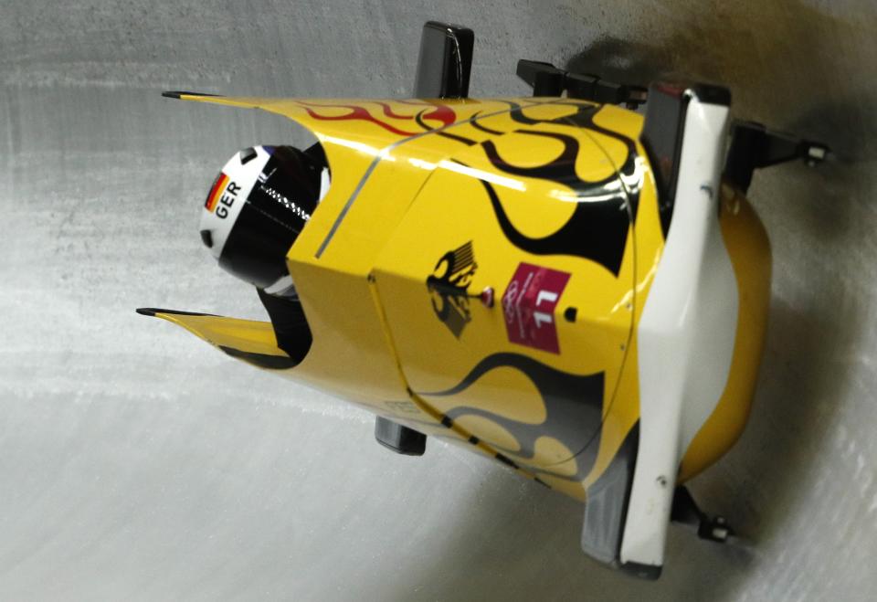 Nico Walther and Christian Poser crashed across the finish line on Sunday to take gold medal position in the second of four bobsled runs. (Reuters)