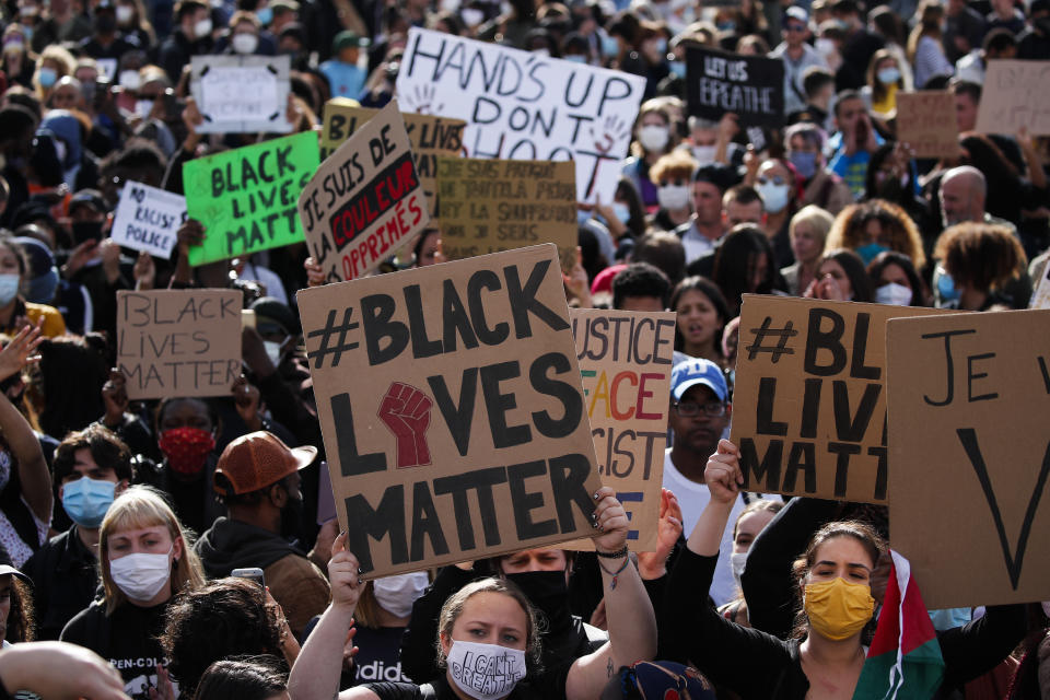 Hundreds of demonstrators gather on the Champs de Mars during a demonstration in Paris, France, Saturday, June 6, 2020, to protest against the recent killing of George Floyd, a black man who died in police custody in Minneapolis, U.S.A., after being restrained by police officers on May 25, 2020. Further protests are planned over the weekend in European cities, some defying restrictions imposed by authorities because of the coronavirus pandemic. (AP Photo/Francois Mori)