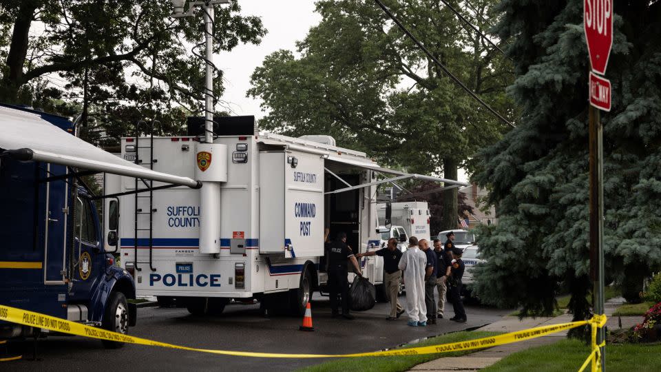 Crime laboratory officers are seen outside Rex Heuermann's home in Massapequa Park on July 18, 2023.  - Yuki Iwamura/AFP/Getty Images