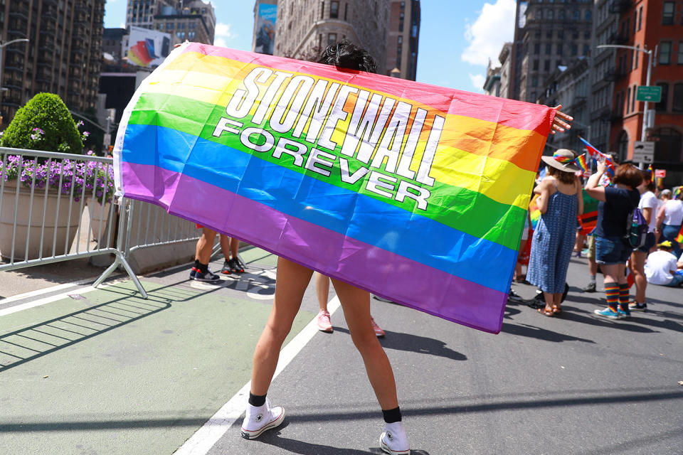 People dance with rainbow flags during the NYC Pride Parade in New York, Sunday, June 30, 2019. (Gordon Donovan/Yahoo News)