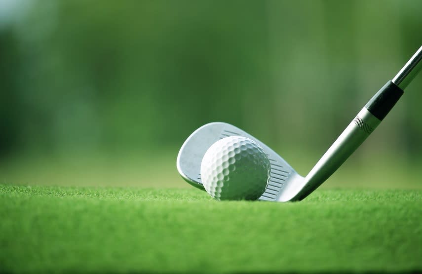 Golf ball with an iron club behind