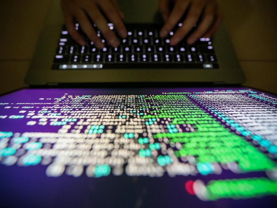 A programmer works on decrypting source code in Taipei, Taiwan (EPA)