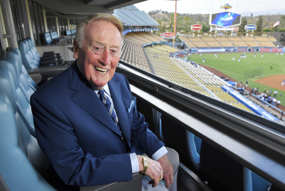 FILE - In this Tuesday, Sept. 20, 2016, photo, broadcaster Vin Scully poses for a photo prior a baseball game between the Los Angeles Dodgers and the San Francisco Giants in Los Angeles. The Hall of Fame broadcaster, whose dulcet tones provided the soundtrack of summer while entertaining and informing Dodgers fans in Brooklyn and Los Angeles for 67 years, died Tuesday night, Aug. 2, 2022. He was 94. (AP Photo/Mark J. Terrill)