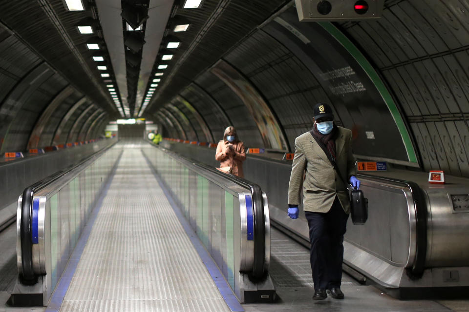 People wearing PPE (personal protective equipment), including face masks as a precautionary measure against COVID-19, walk to take a London Underground Tube train in the evening rush hour at Waterloo station on May 11, 2020, as life in Britain continues during the nationwide lockdown due to the novel coronavirus pandemic. - The British government on Monday published what it said was a "cautious roadmap" to ease the seven-week coronavirus lockdown in England, notably recommending people wear facemasks in some public settings. But the devolved governments in Scotland and Wales have opted for a more cautious approach, keeping the strictest stay-at-home measures in place to contain the outbreak. (Photo by ISABEL INFANTES / AFP) (Photo by ISABEL INFANTES/AFP via Getty Images)