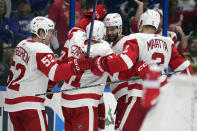 Detroit Red Wings' Jonatan Berggren (52) celebrates with teammates, including defenseman Olli Maatta (2) after scoring against the Tampa Bay Lightning during the third period of an NHL hockey game Tuesday, Dec. 6, 2022, in Tampa, Fla. (AP Photo/Chris O'Meara)