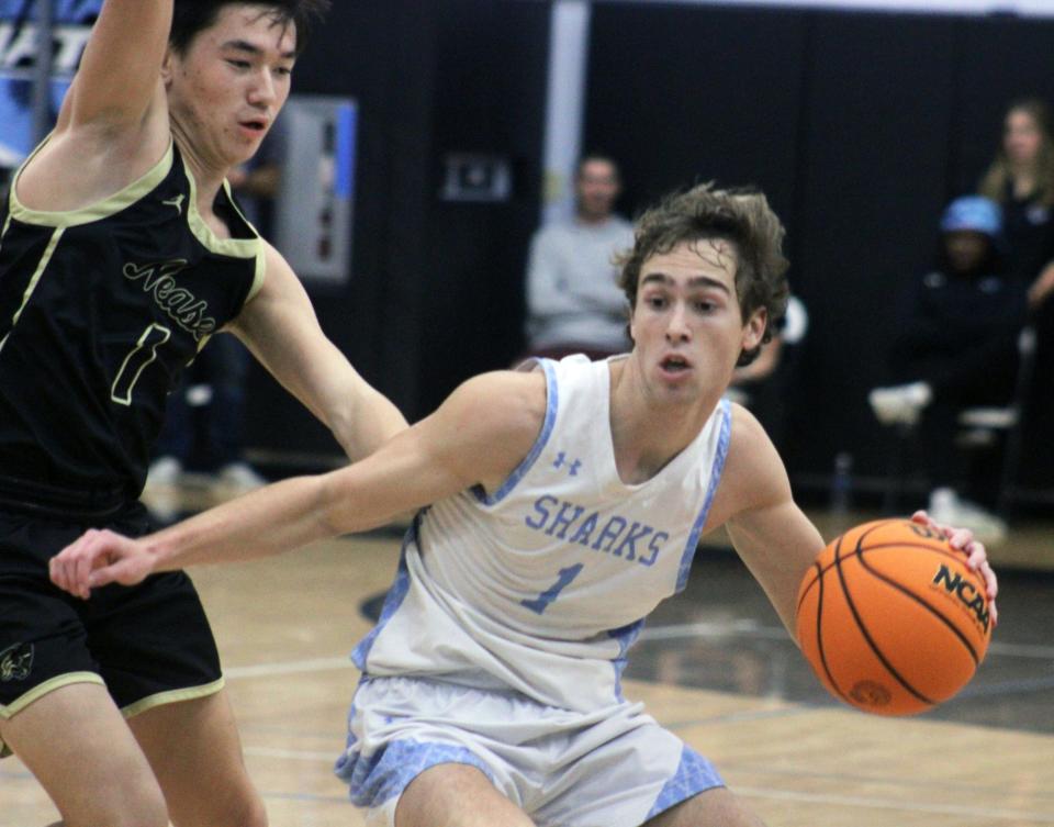 Ponte Vedra guard Sam Ritchie (1) dribbles into the lane as Nease's Joe Wholey (left) defends during a high school boys basketball game on December 15, 2023. [Clayton Freeman/Florida Times-Union]