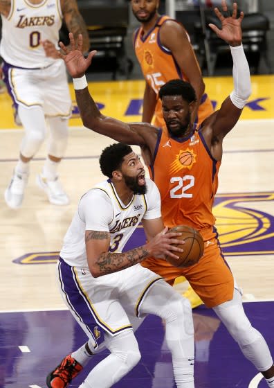 LOS ANGELES, CA - MAY 30: Los Angeles Lakers forward Anthony Davis (3) is guarded by Phoenix Suns center Deandre Ayton.