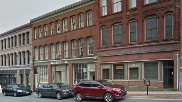 52 Canterbury St., centre, houses a printing shop on the ground floor, other businesses on the second floor, and the third floor is currently rented out to musicians. (Google Street View - image credit)