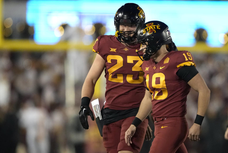 Iowa State linebacker Will McLaughlin (23) congratulates place-kicker Chase Contreraz (19) on a field goal during the first half of an NCAA college football game against Texas, Saturday, Nov. 18, 2023, in Ames, Iowa. (AP Photo/Matthew Putney)