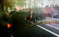 <p>Police advance toward counterprotesters during a rally by the Patriot Prayer group in Portland, Ore., Aug. 4, 2018. (Photo: Bob Strong/Reuters) </p>