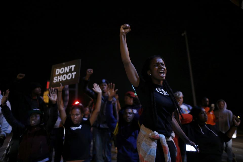 Protesters cheer after blocking an intersection after a vigil in St. Louis, Missouri, October 9, 2014. A 32-year-old white St. Louis police officer fatally shot 18-year-old Vonderrit Myers Jr. after the officer, who was off duty working for a private security company, saw Myers and two friends running and pursued them, according to a statement issued by the St. Louis police department. (REUTERS/Jim Young)