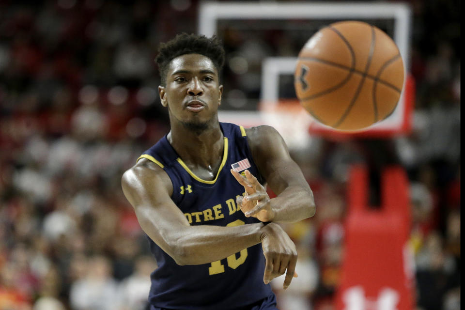 Notre Dame guard TJ Gibbs passes to a teammate against Maryland during the first half of an NCAA college basketball game, Wednesday, Dec. 4, 2019, in College Park, Md. (AP Photo/Julio Cortez)