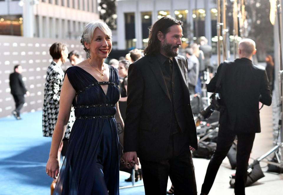 Yep, they're linking fingers at the Los Angeles County Museum of Art event. (Photo: Emma McIntyre via Getty Images)