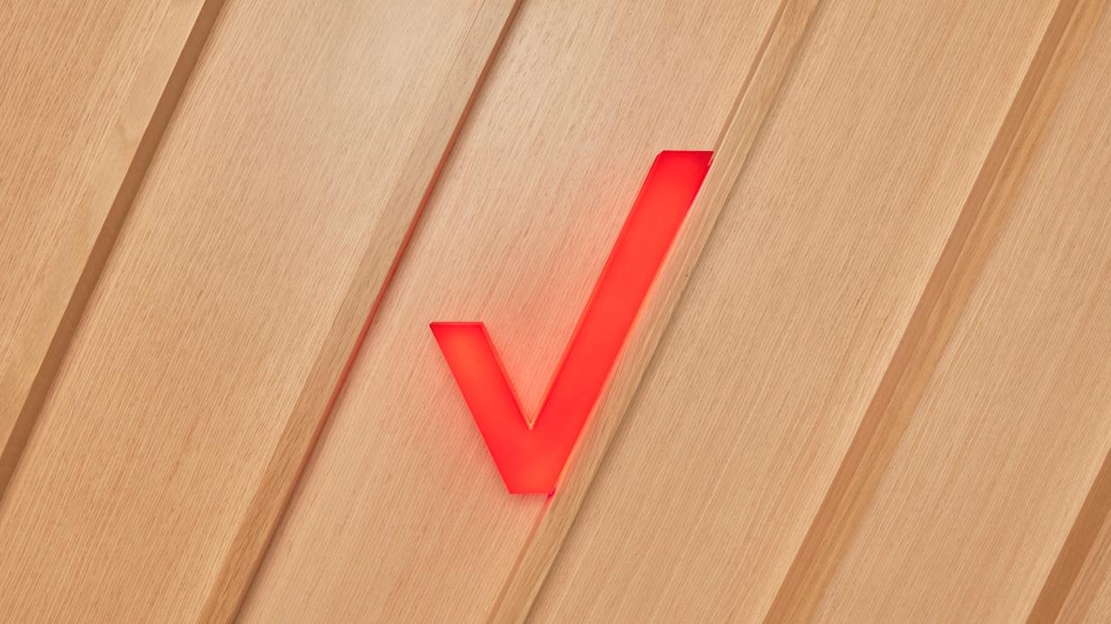  Verizon check mark on wood. 