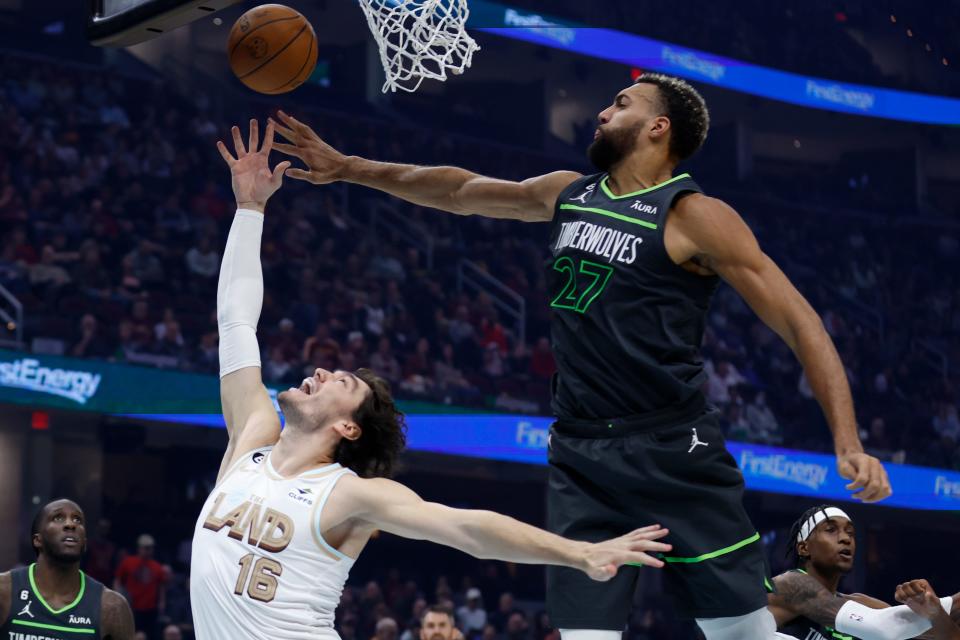 Cleveland Cavaliers forward Cedi Osman (16) shoots against Minnesota Timberwolves center Rudy Gobert (27) during the first half of an NBA basketball game, Sunday, Nov. 13, 2022, in Cleveland. (AP Photo/Ron Schwane)