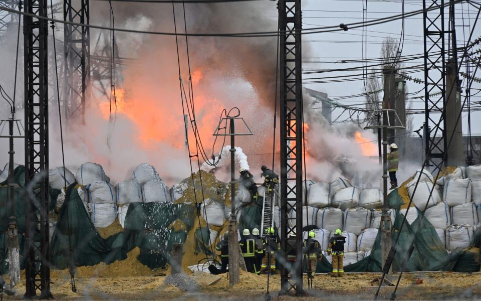 Firefighters extinguish a fire at an electrical substation after a missile attack in Kharkiv