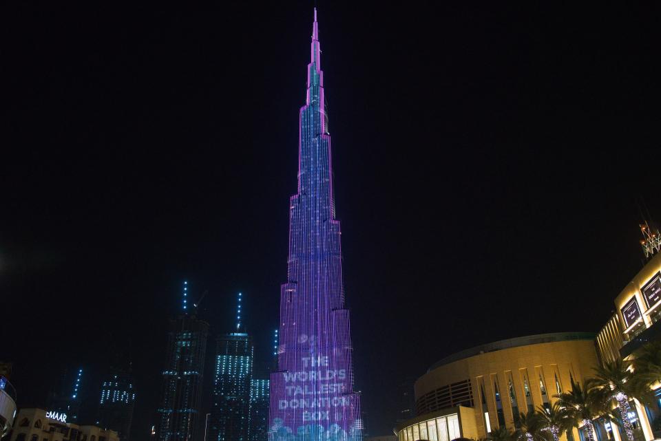 The Burj Khalifa, the world's tallest building, displays a message as part of the "World's Tallest Donation Box" campaign in Dubai, United Arab Emirates, Monday, May 11, 2020. The campaign raised money for meals to the hungry amid the coronavirus pandemic. (AP Photo/Jon Gambrell)