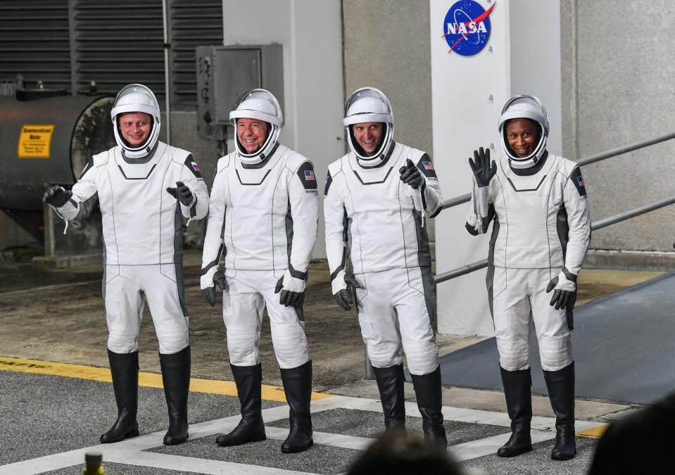 Crew-8 astronauts Alexander Grebenkin, Michael Barrett, Matthew Dominick and Jeanette Epps wave to media as they head to the launch pad Sunday night.