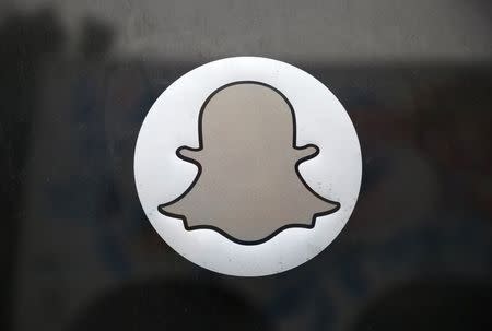 The Snapchat logo is seen on the door of their headquarters in Venice, Los Angeles, California October 13, 2014. REUTERS/Lucy Nicholson