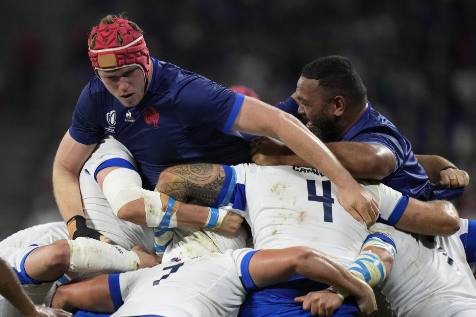 France's Thibaud Flament, left, in the scrum during the Rugby World Cup Pool A match between France and Italy at the OL Stadium in Lyon, France, Friday, Oct. 6, 2023. (AP Photo/Pavel Golovkin)