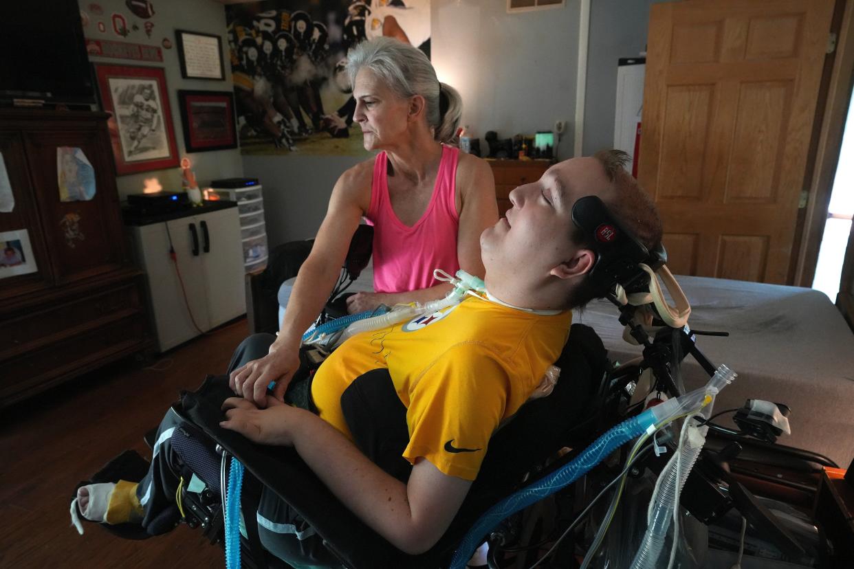 Beth Malarkey tries to stabilize her son Alex Malarkey at their longtime home in Huntsville in this 2022 file photo. They later moved new home in Bellefontaine that was retrofitted by the Logan County Department of Developmental Disabilities.