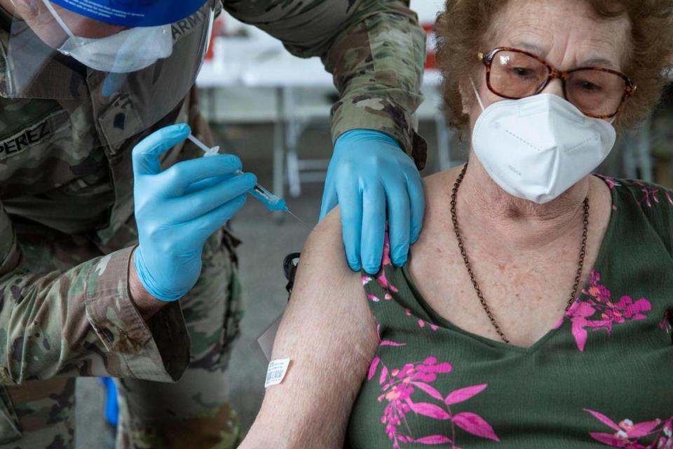 Loida Mendez, 86, is injected with Pfizers COVID-19 vaccine during opening day at the FEMA vaccination site on Miami-Dade College’s North Campus on Wednesday, March 3, 2021.