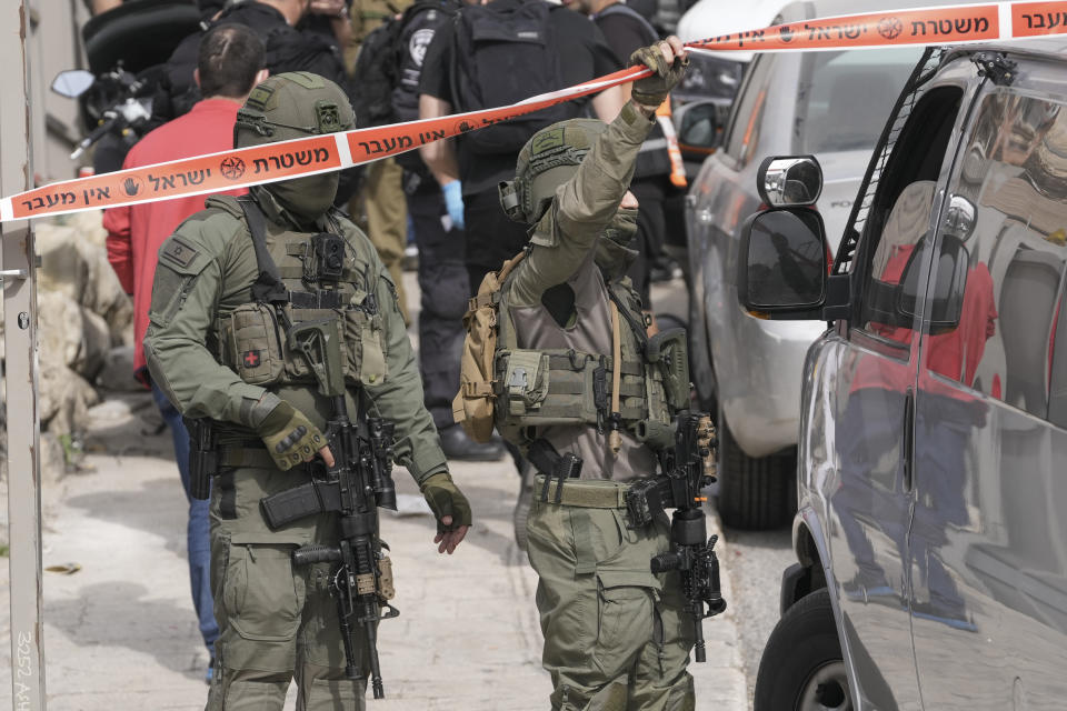 Israeli policemen secure a shooting attack site in east Jerusalem, Saturday, Jan. 28, 2023. A Palestinian gunman opened fire in east Jerusalem on Saturday, wounding at least two people less than a day after another attacker killed seven outside a synagogue there in the deadliest attack in the city since 2008. (AP Photo/Mahmoud Illean)