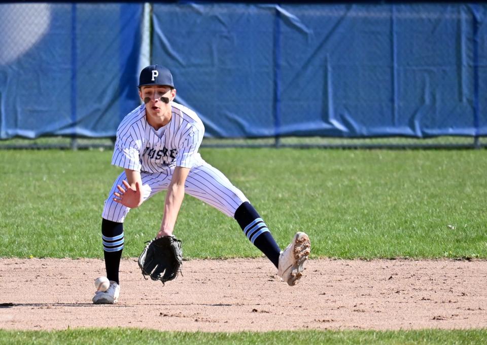 Petoskey's Garrett Wodek fields a ball at shortstop against Greenville on Saturday during a hosted tournament.