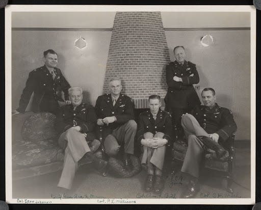 A photograph of six officers, taken at the United States Eighth Air Force unit headquarters at High Wycombe, England. Three hundred fifty thousand American servicemen served as part of the unit alongside the British Royal Air Force. From left to right in the photograph: Colonel Leon Johnson, Brigadier General Asa N. Duncan, Colonel Paul L. Williams, Colonel Charles R. Booth, Colonel Charles A. Jones, and Colonel Clarence H. Welch.