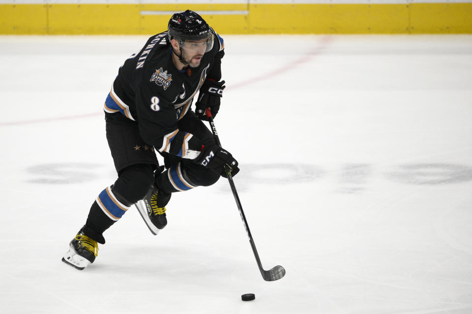 Washington Capitals left wing Alex Ovechkin (8) skates with the puck during the third period of an NHL hockey game against the Montreal Canadiens, Saturday, Dec. 31, 2022, in Washington. (AP Photo/Nick Wass)