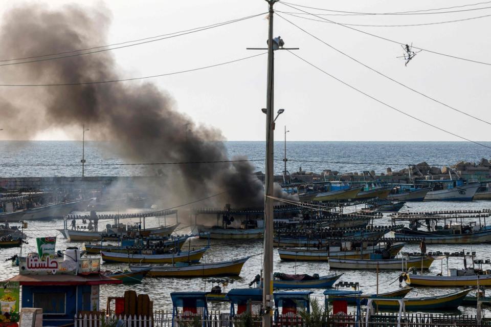 A plume of smoke rises above the port in the Gaza Strip after an Israeli air strike on Sunday (AFP via Getty Images)