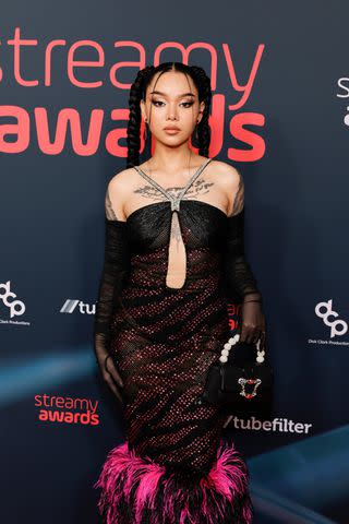 <p>Matt Winkelmeyer/Getty</p> Bella Poarch's dominatrix-style plaits at the 2023 Streamy Awards