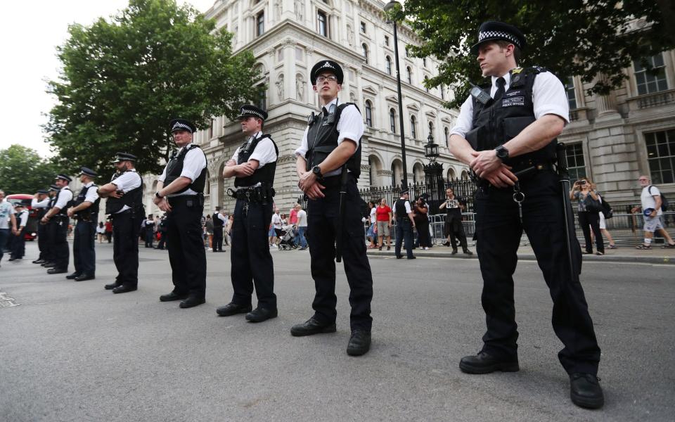 Police line Whitehall, London, as protesters demand answers and justice over the Grenfell Tower disaster - Credit: Jonathan Brady/PA